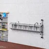 A ladder rack mounted on a concrete wall in a garage or workshop. Produktbild-Vorschau