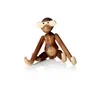 A wooden monkey toy is sitting on a white background. Náhled obrázku produktu