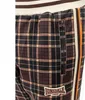 A close-up view of the side of a pair of plaid trousers, showing a zippered pocket and a side stripe. Anteprima dell’immagine prodotto