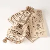 A wooden 3D puzzle of a hurdy-gurdy is shown on a white background, with unassembled puzzle pieces fanned out behind it. Produktbild-Vorschau