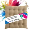 A beige seat cushion with ties, placed against a background of colorful powder explosions. Náhľad obrázku produktu