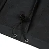 A close-up view of the bottom hem of a black jacket, showing a drawstring and grommets. Produktbild-Vorschau