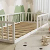 A white wooden bed frame with slatted base in a child's room with mountain-themed wallpaper. Anteprima dell’immagine prodotto