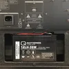 A close-up view of a black rechargeable battery installed in a device. Produktbild-Vorschau
