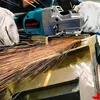 A person is using an angle grinder to cut metal, creating a shower of sparks. Voir les images du produit
