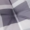 A close-up view of a gray and white checkered cushion. Produktbild-Vorschau