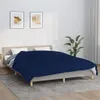 A bedroom scene with a bed covered by a navy blue blanket. Voir les images du produit