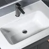 A close-up view of a white bathroom sink with a dark faucet. Náhled obrázku produktu