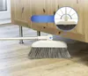 A broom with a rotating head is shown cleaning under a wooden cabinet. Náhľad obrázku produktu