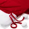 A close-up view of a red velvet Christmas sack with white trim and two white pom-poms attached to red ties. Produktbild-Vorschau