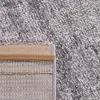 A close-up view of the corner of a rug, showing the texture of the pile and the backing material. Produktbild-Vorschau