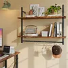 A wall-mounted shelf unit with various items displayed on it, including books, a speaker, decorative items, and a hat. Anteprima dell’immagine prodotto