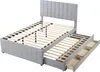 A grey upholstered bed frame with a slatted base and three pull-out drawers, shown from a diagonal angle. Produktbild-Vorschau