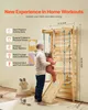 A father is holding his child on a wooden indoor climbing structure. Anteprima dell’immagine prodotto