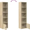 Two identical tall, narrow bookshelves are shown side-by-side against a white background. The bookshelf on the left has its bottom door slightly ajar, revealing a small black knob. The bookshelf on the right also has its bottom door ajar, showing the inter Náhled obrázku produktu