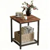 A square side table with a wooden top and metal frame, decorated with a vase of flowers, a small radio, and a candle on top, and a basket of books on the lower shelf. Produktbild-Vorschau