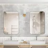 A modern bathroom with two sinks, mirrors, and a marble-tiled wall. Produktbild-Vorschau