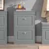 A gray entryway cabinet with two drawers, placed on a wooden floor against a gray wall. Náhľad obrázku produktu