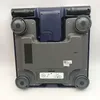 The underside of a blue and gray Omron BF511 body composition scale. Podgląd zdjęcia produktu