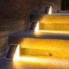 Solar lights illuminating outdoor steps at night. Produktbild-Vorschau