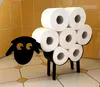 A black sheep-shaped toilet paper holder filled with toilet paper rolls, set against a yellow tiled wall and a tiled floor. Anteprima dell’immagine prodotto