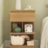 A wooden nightstand with decorative items on its shelves. Náhled obrázku produktu