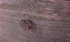 A close-up shot of a wooden drawer knob on a wooden surface. Náhľad obrázku produktu