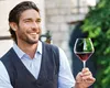 A man is holding a glass of red wine. Podgląd zdjęcia produktu
