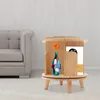 A wooden rotating shelf with a vase and a book, next to a sofa. Náhled obrázku produktu