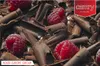 A close-up of chocolate shavings and raspberries, with brand logos in the corner. Podgląd zdjęcia produktu