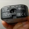 A close-up view of the bottom of a black electronic device, showing various labels and markings. Anteprima dell’immagine prodotto
