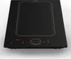 A black induction cooktop with gold trim and a digital display. Podgląd zdjęcia produktu