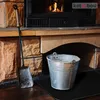 A fireplace hearth with a shovel and a metal bucket. Anteprima dell’immagine prodotto