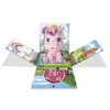 A pop-up box with a pink unicorn toy in the center, surrounded by colorful scenes. Podgląd zdjęcia produktu