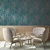 A seating area with chairs and a table, set against a patterned wallpaper and wooden paneling. Náhľad obrázku produktu