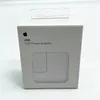 A white box with an Apple logo and product details for a 12W USB Power Adapter. Náhľad obrázku produktu