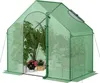 A green greenhouse filled with various potted plants. Podgląd zdjęcia produktu