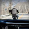 A car's dashboard with a phone mount attached to the windshield. Produktbild-Vorschau