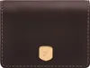 A close-up, front-facing view of a dark brown leather wallet with a gold crest logo.