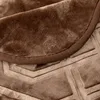 A close-up view of a brown, plush blanket with a textured pattern and a stitched edge. Podgląd zdjęcia produktu