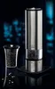 A set of PEUGEOT pepper and salt grinders on a reflective black surface with a blurred blue background. Náhled obrázku produktu