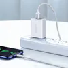 A white USB-A to USB-C charging cable is plugged into a white power adapter, which is plugged into a white power strip. The other end of the cable is plugged into a smartphone. Produktbild-Vorschau