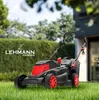 A Lehmann Garden electric lawnmower is shown on a green lawn in front of a house and hedge. Náhled obrázku produktu
