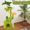 A multi-level cat tree with green carpeting and yellow platforms, set against a light background with a potted plant to the right. Náhled obrázku produktu