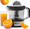 A close-up product shot of an electric citrus juicer, with a glass of orange juice, a cut orange, and a whole orange. Produktbild-Vorschau