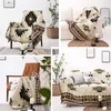 Collage of four images showing a boho-style throw blanket with geometric patterns draped over furniture and on display. Produktbild-Vorschau