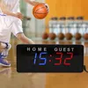 A basketball player is dribbling a ball on a court, with a digital scoreboard in the foreground. Náhled obrázku produktu