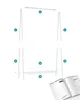 An image showing the assembly process of a white garment rack, with parts labeled and a manual visible. Produktbild-Vorschau