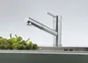 A modern kitchen faucet is shown next to a pile of green peppers in a sink. Anteprima dell’immagine prodotto