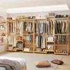 A bedroom scene with a large wooden clothing rack filled with clothes and accessories. Produktbild-Vorschau